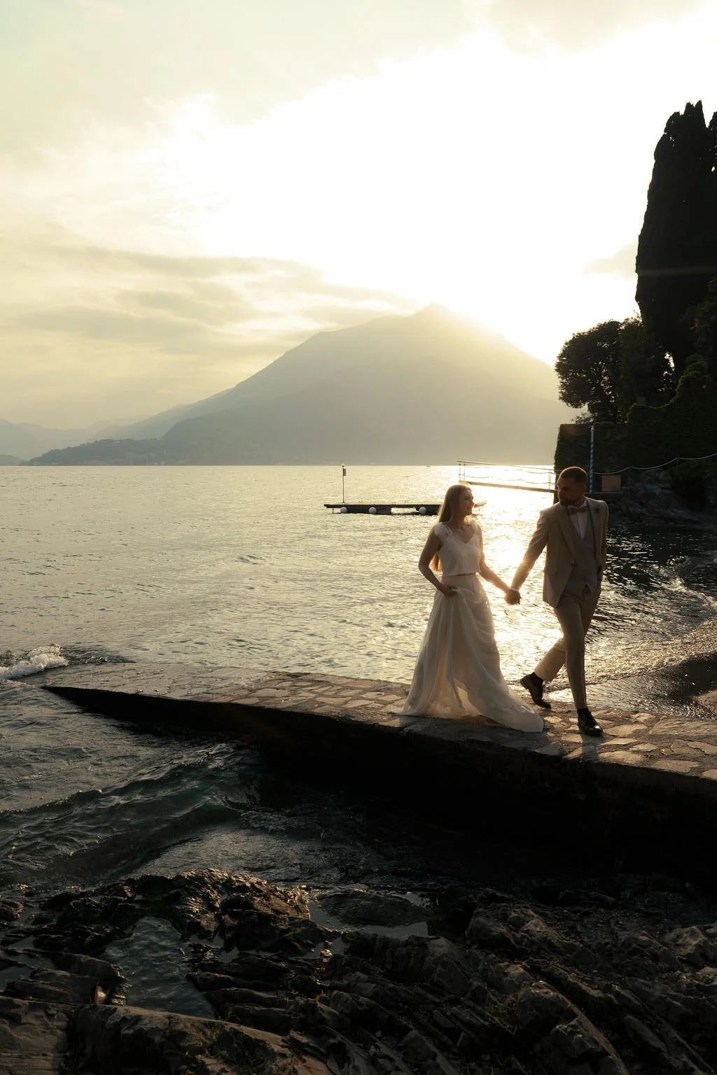Couple walking at the lake como during sunset, captured in Varenna, Italy.