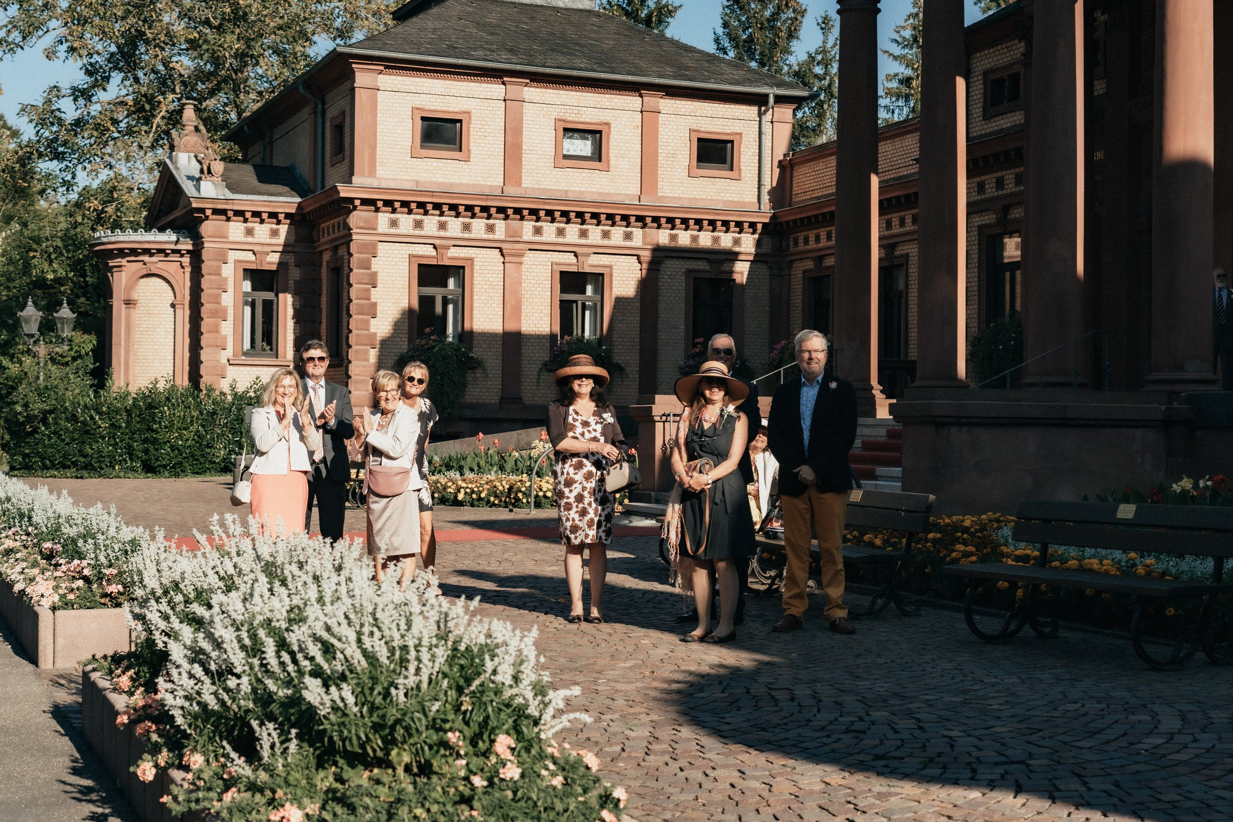 Wedding guests waiting for the couple to arrive before the ceremony, Bad Homburg, Germany.