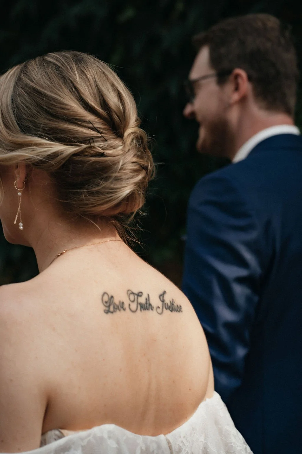Details of bride´s back tattoo as couple walk by photographed by Jessica Di Salvo.