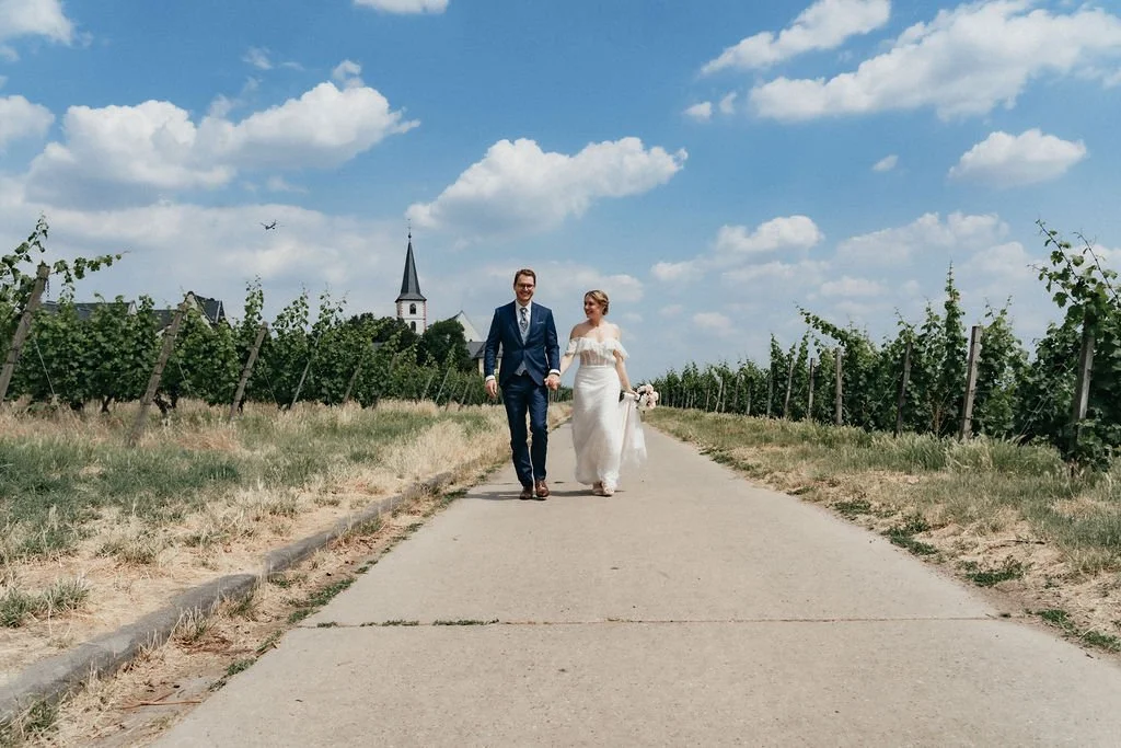 Dramatic cinematic picture of a married couple walking side by side by  photographer Jessica Di Salvo.