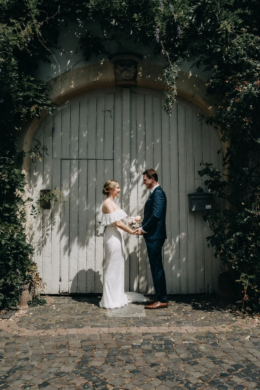 Bride and groom looking and smiling at each other  by wedding photographer Jessica Di Salvo.