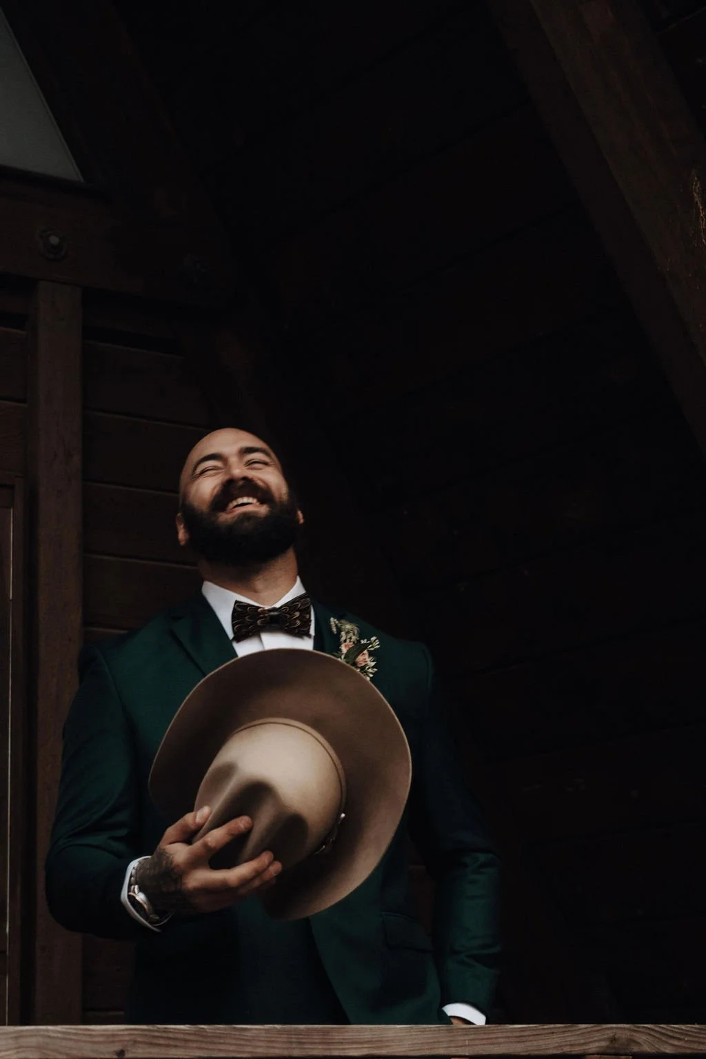 Laughing groom at elopement wedding by cinematic wedding photographer Jessica Di Salvo.