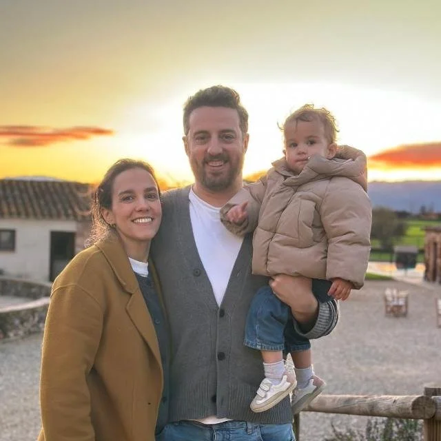David and Elena with their family at sunset