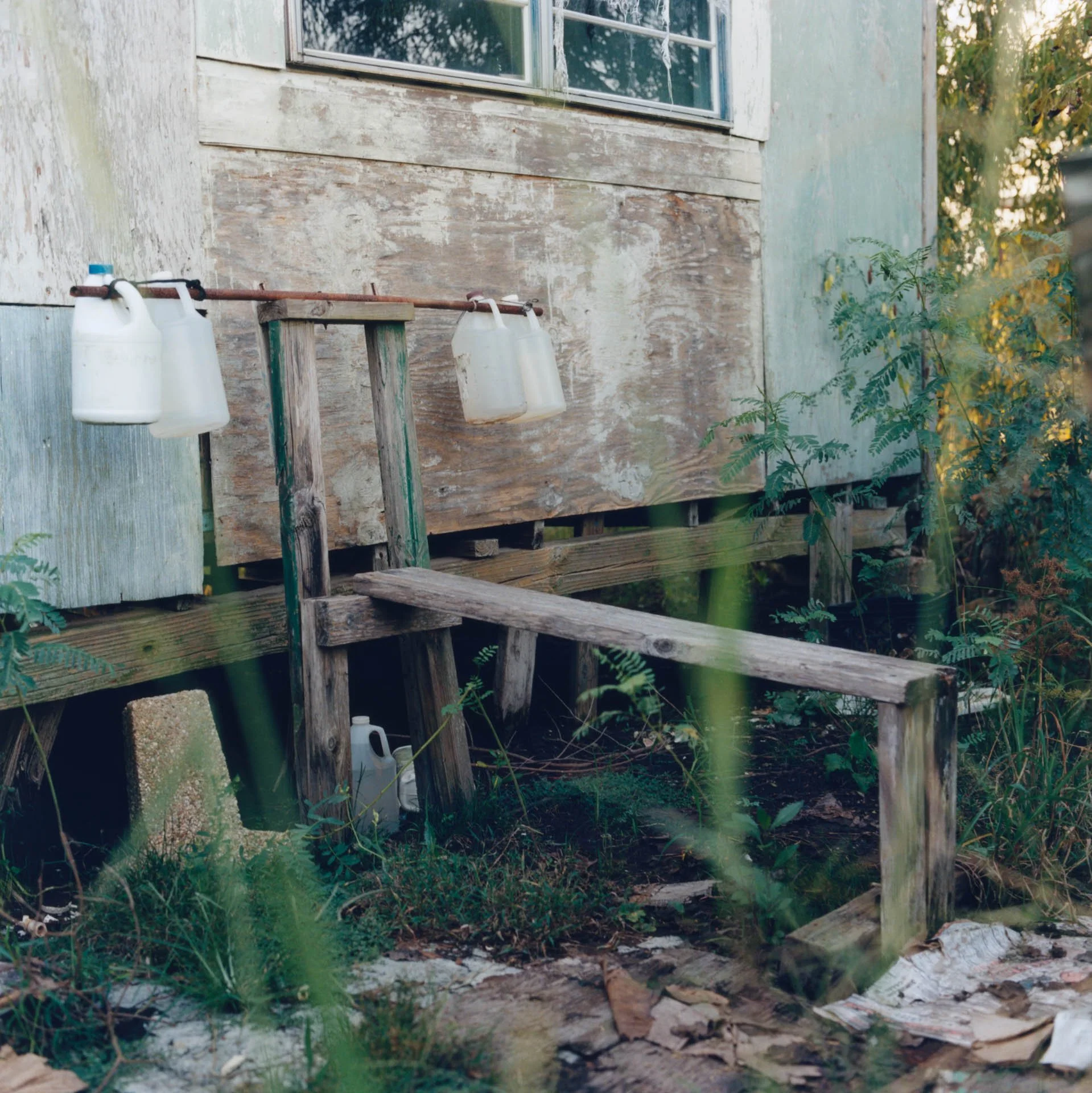 Edison's bench press and bar at the back of his house.