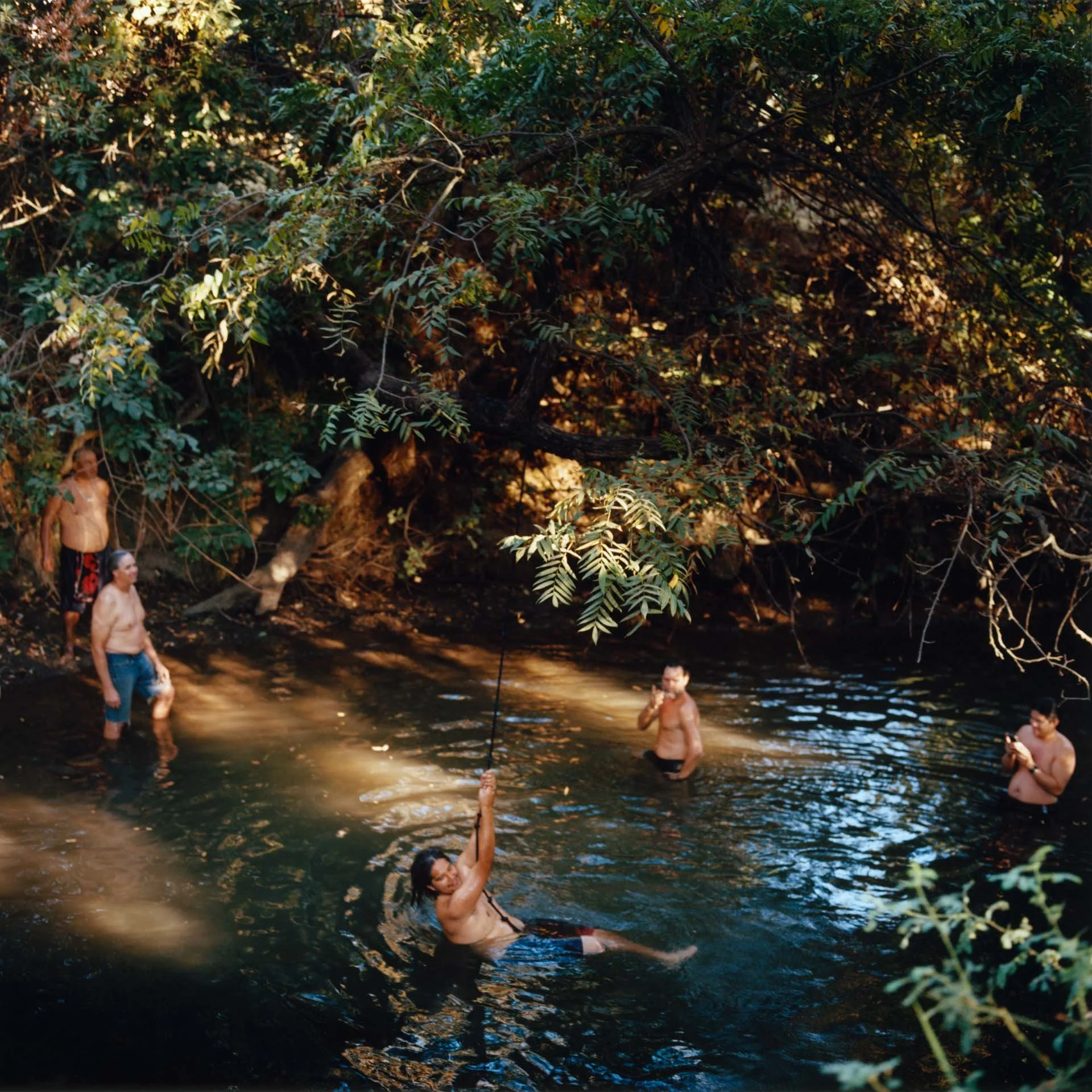 Tribal members of the Winemem Wintu Tribe take a break from the sun to swim in a watering hole near Chico, CA.  They are on a 375-mile, two-week journey to Mt. Shasta from the San Francisco Bay to raise awareness to the extinction their sacred Chinoo