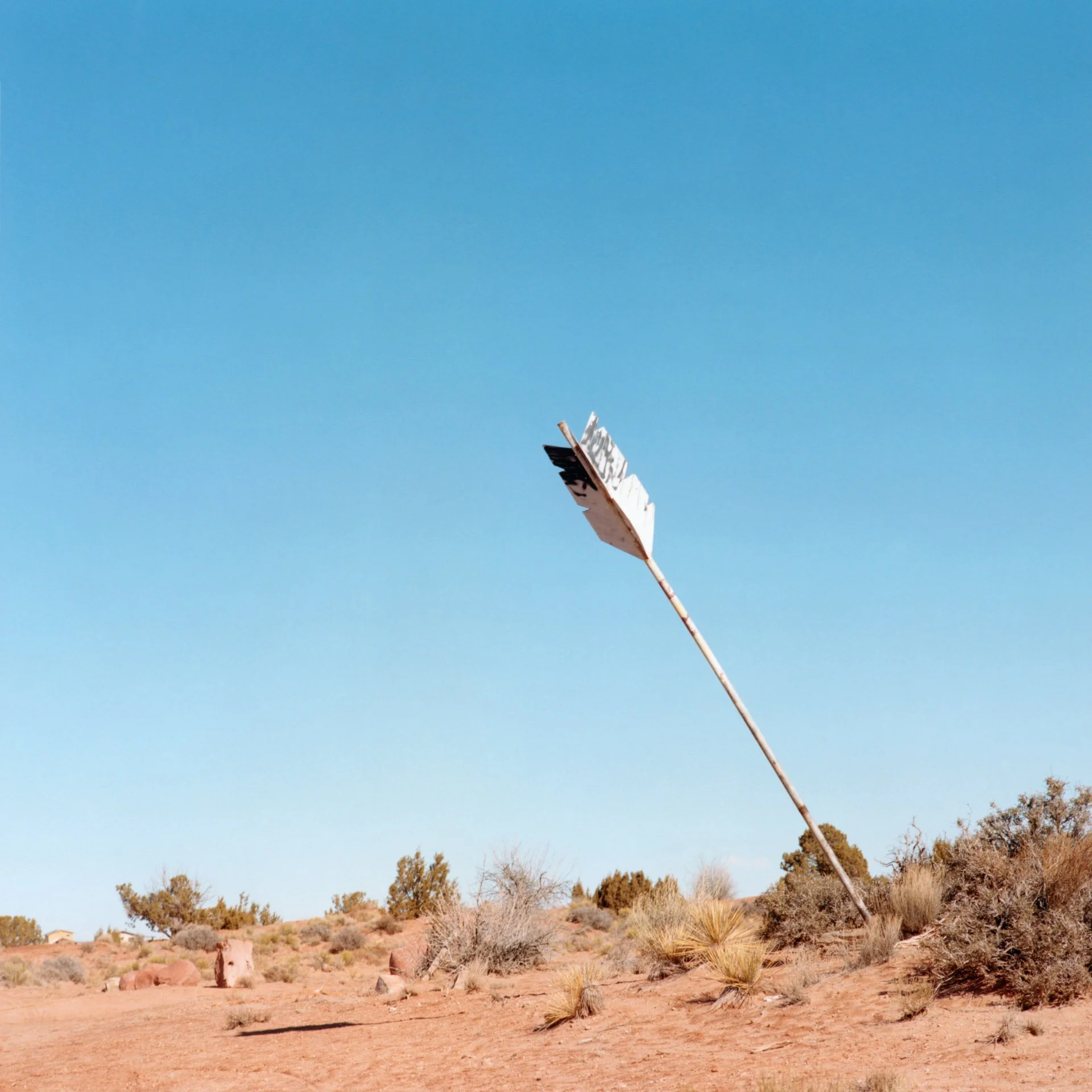 An arrow sculpture within the landscape of Monument Valley.