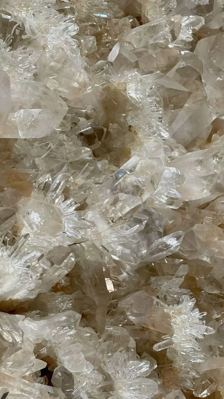 Close-up of a large pile of clear, irregularly shaped quartz crystals.