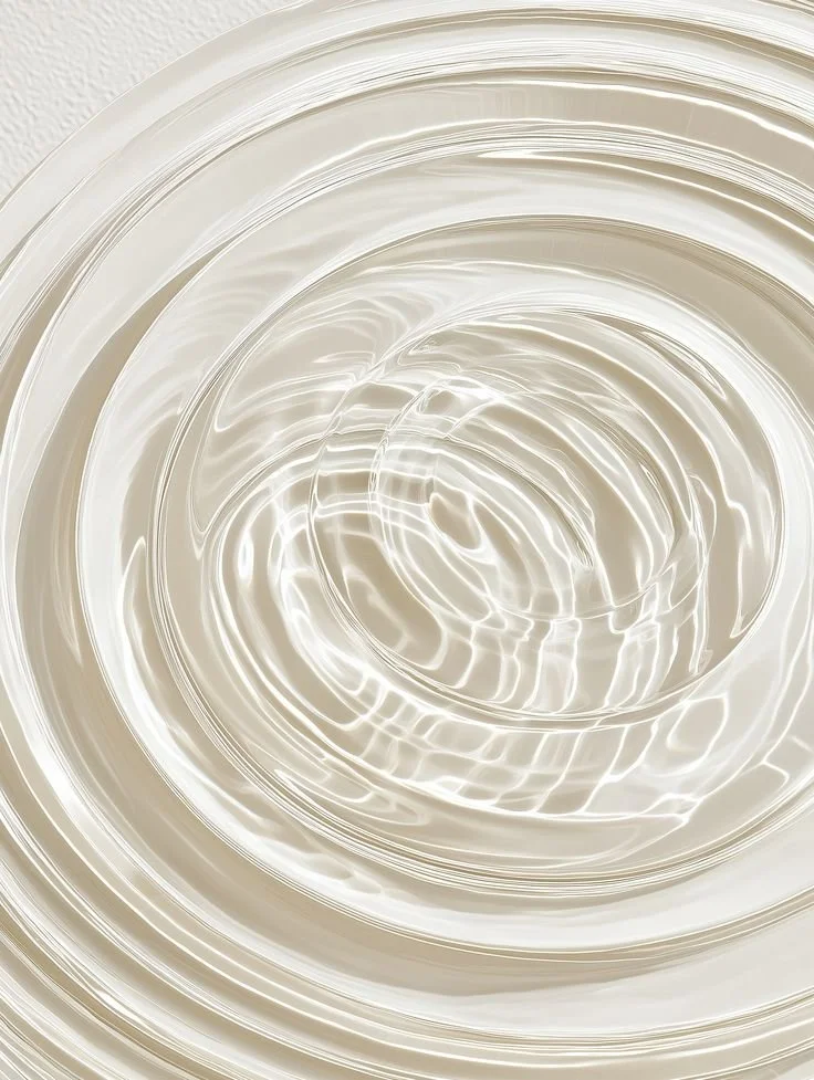 Close-up of a shiny, metallic, spiral-shaped object with swirling reflections.