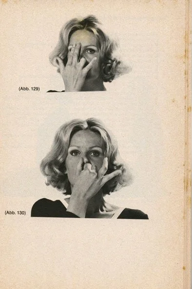 Black and white photo of a woman with wavy hair demonstrating hand placement on her nose and face in two different positions.