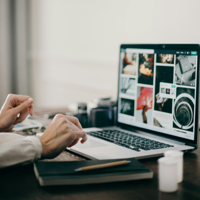 man on laptop looking at their photography portfolio website
