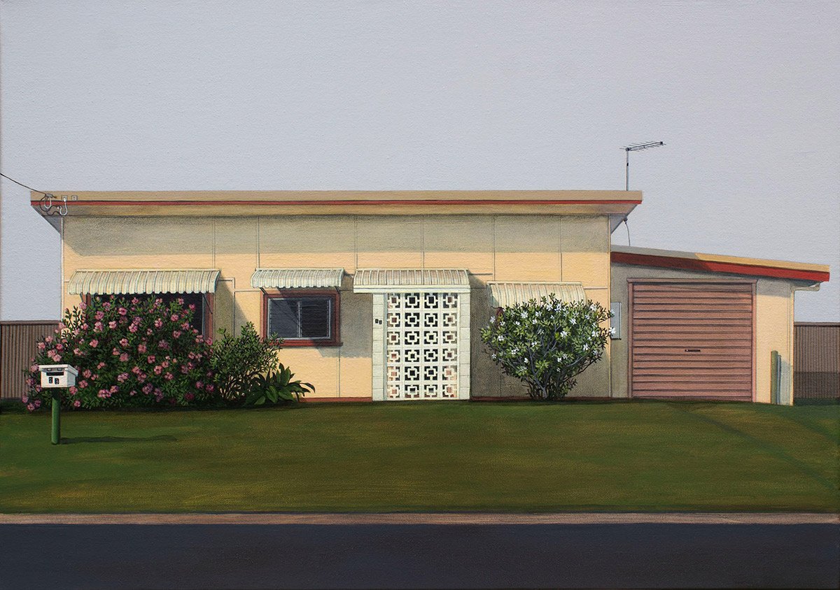 A single-story house with beige exterior walls, a red garage door, and three small awnings over the windows. There are bushes and grass in front, and a mailbox on a pole near the sidewalk.