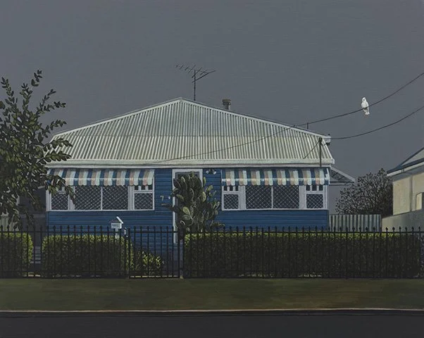 A house with a blue exterior, white roof, striped awning, and a fenced yard under a dark, cloudy sky.