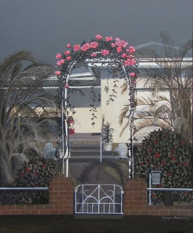 Garden arch with pink flowers, surrounded by lush plants and a white picket gate.
