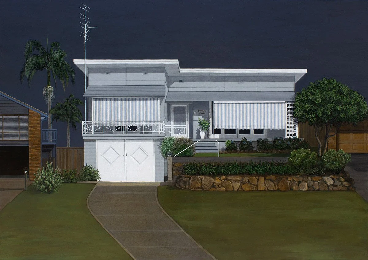 A modern white house with a curved driveway, front steps, and striped awnings over the windows, surrounded by landscaped garden with trees, shrubs, and a rock border, dark night sky in the background.