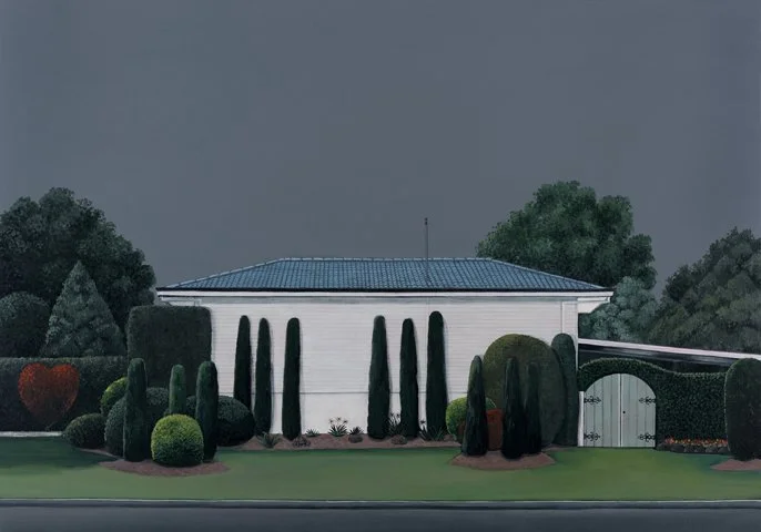 A white building with a blue roof, surrounded by neatly trimmed tall cypress trees and round bushes in a landscaped yard under a cloudy sky.