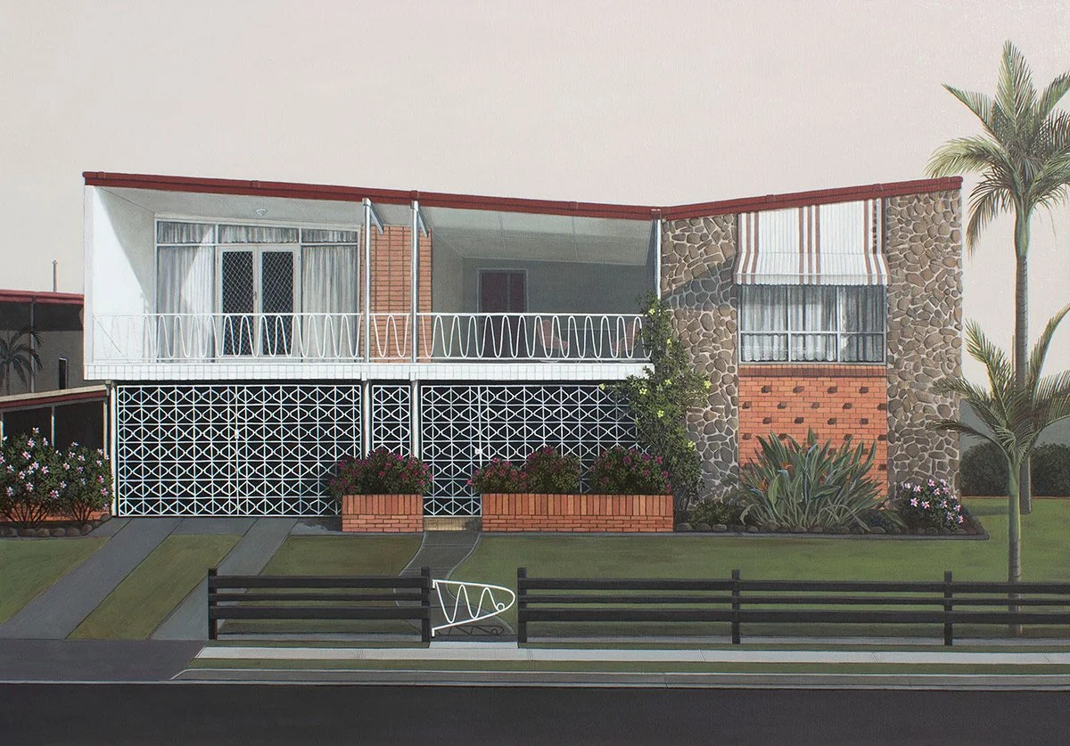 A mid-century modern house with a white upper floor and a decorated stone and brick facade, featuring a balcony, landscaped garden, and palm trees.