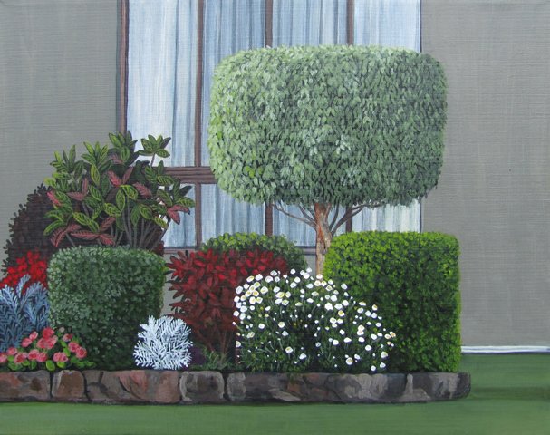 A landscaped indoor garden with various shrubs and flowers, including a tall round topiary tree, surrounded by smaller bushes and blooming plants, with a window in the background.
