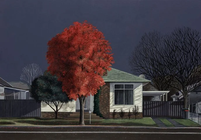 A house with a green roof, white walls, and a brick base, surrounded by trees, including a large red-leafed tree in front, and a fence and street in the foreground, under a dark sky.