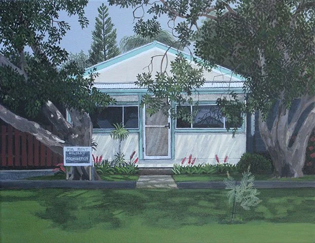A house with a porch, surrounded by trees and bushes, with a 