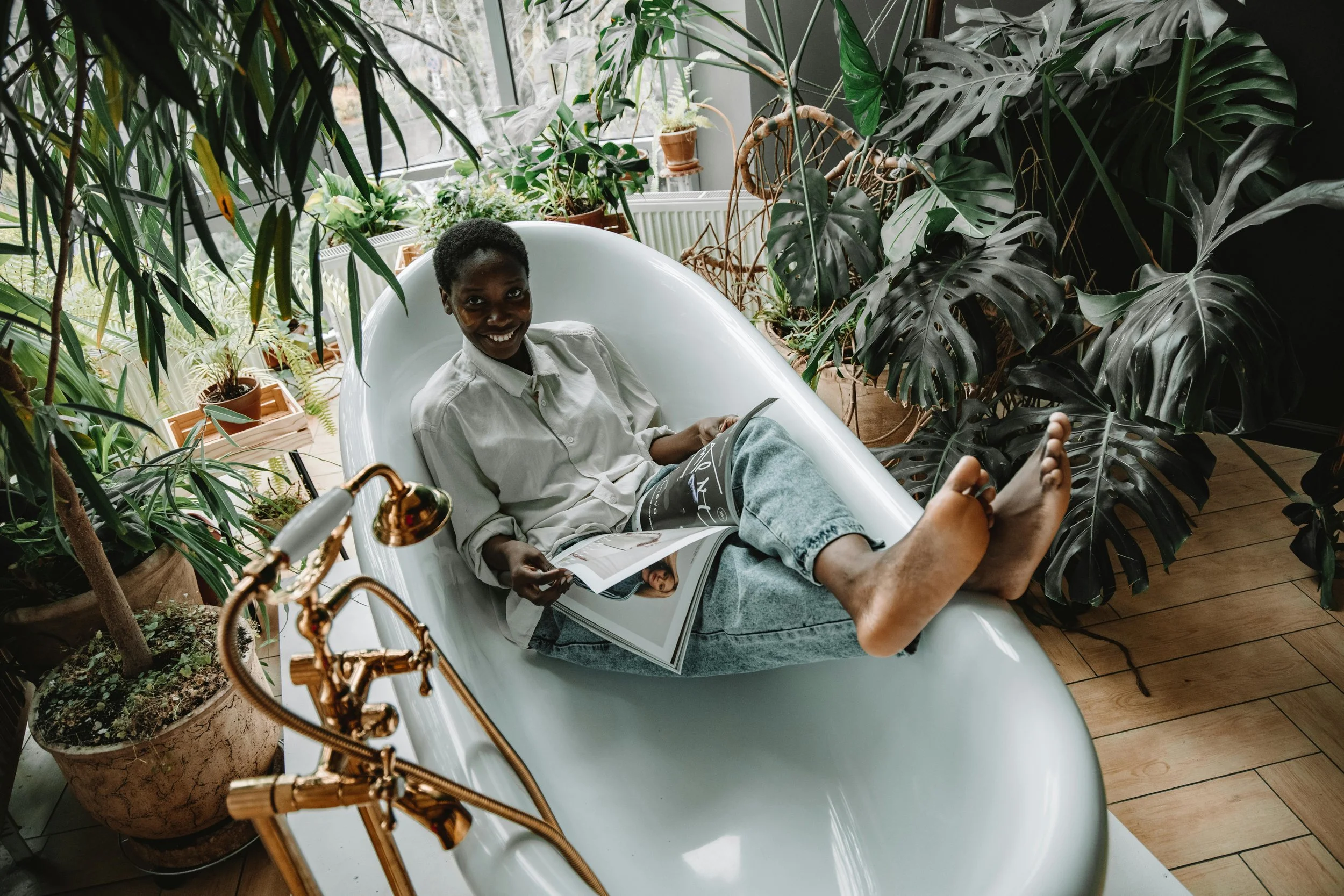 Happy black woman reading magazine