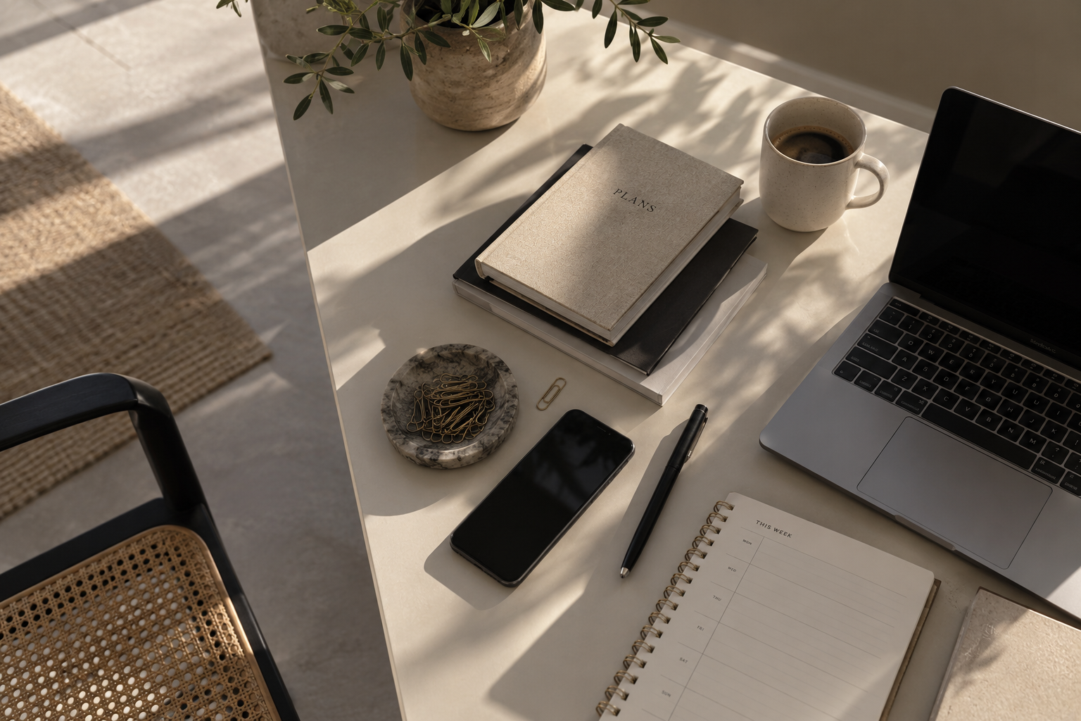 Virtual assistant workspace with laptop, planner and coffee
