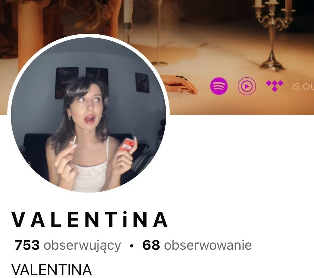 A screenshot of a social media profile for Valentina. The profile picture shows a young woman with shoulder-length brown hair, wearing a white top, holding a small object with a surprised or expressive facial expression. The background includes a dark-colored couch and framed pictures on the wall. The cover image background is dimly lit with candles and contains logos for Spotify, Apple Music, and Tidal.