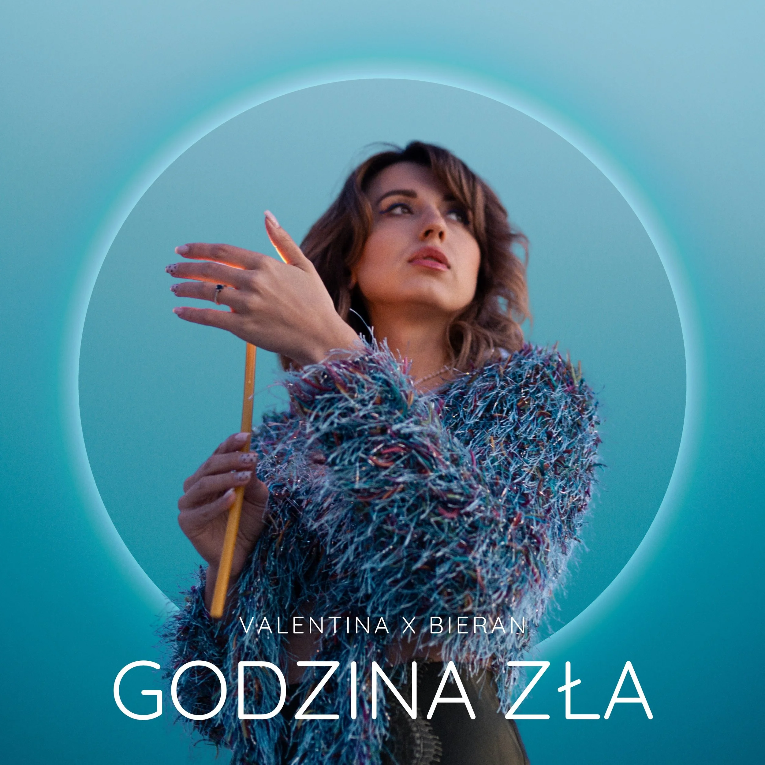 A woman with brown hair posing against a blue sky, wearing a colorful fuzzy jacket, with text saying 'Valentina x Bieran' and 'Godzina Zła' overlaid on the image.
