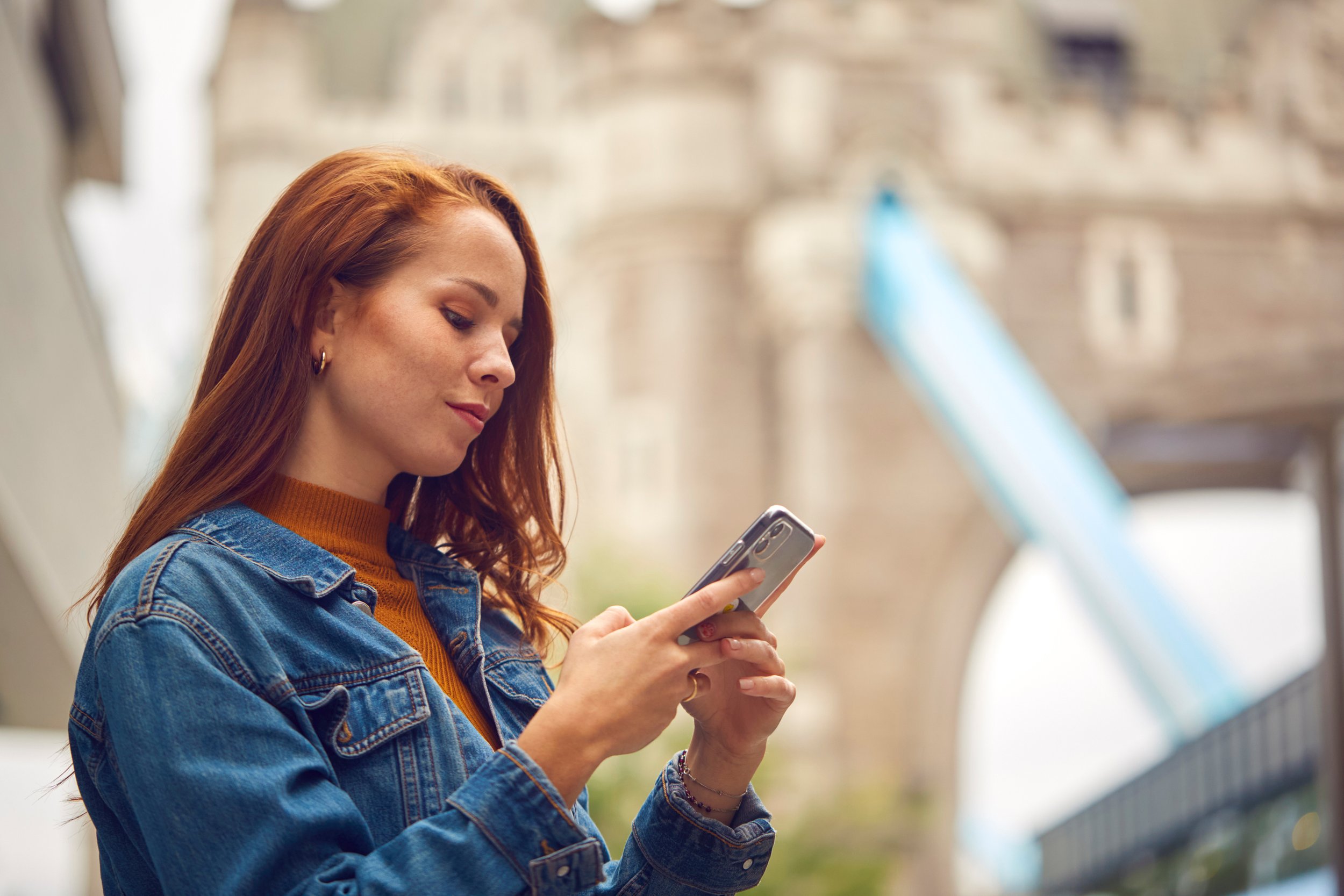 A traveller using a smartphone while exploring a city.