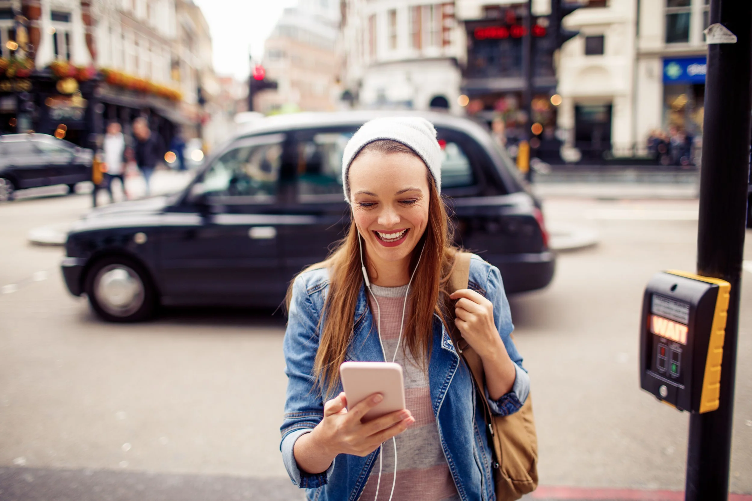 A visitor using a smartphone in London to explore nearby experiences.