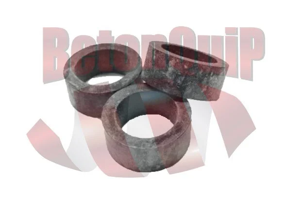 Three metal washers, one standing upright and two lying flat, with a worn and rusty appearance.