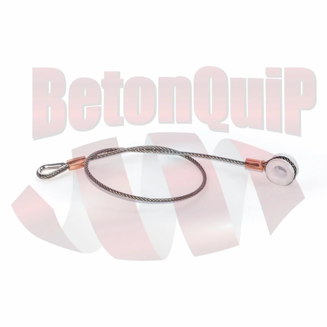 A metal bracelet with a wire design and a white bead attached to one end, laid on a white surface with a faint 'BetonQup' logo in the background.