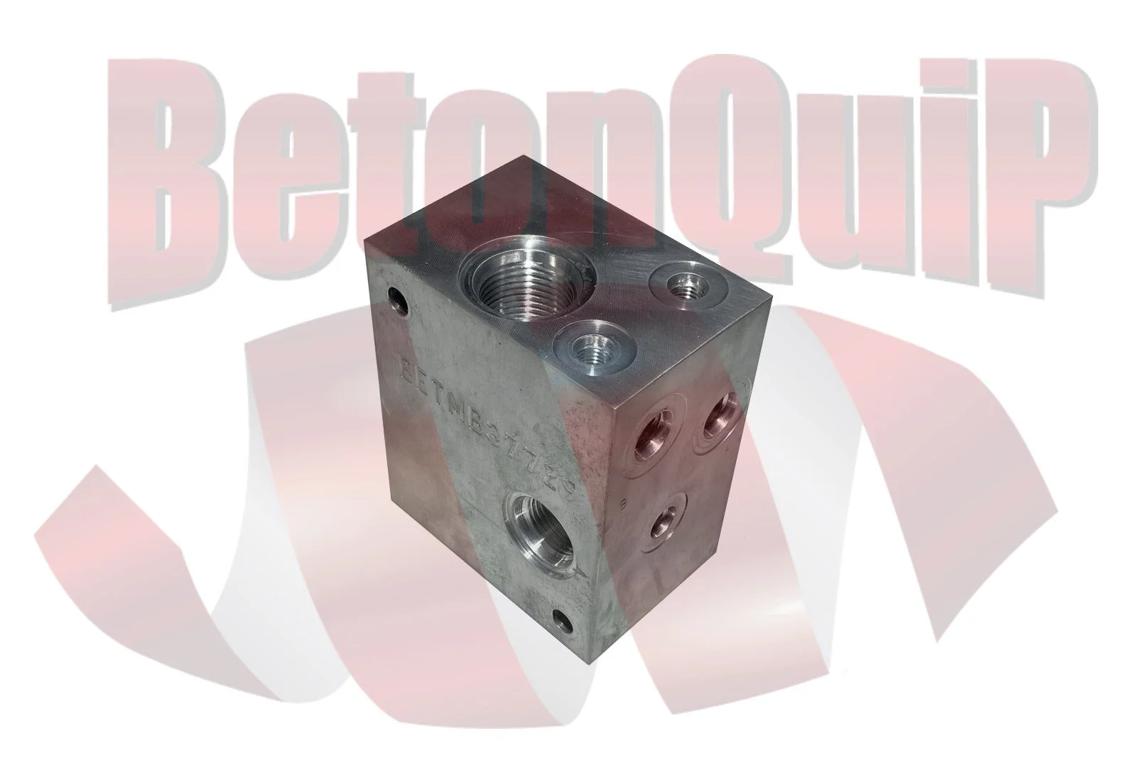 A metal hydraulic valve block with multiple ports and threaded openings, placed on a background with the words "Bettenbacher" faintly visible.