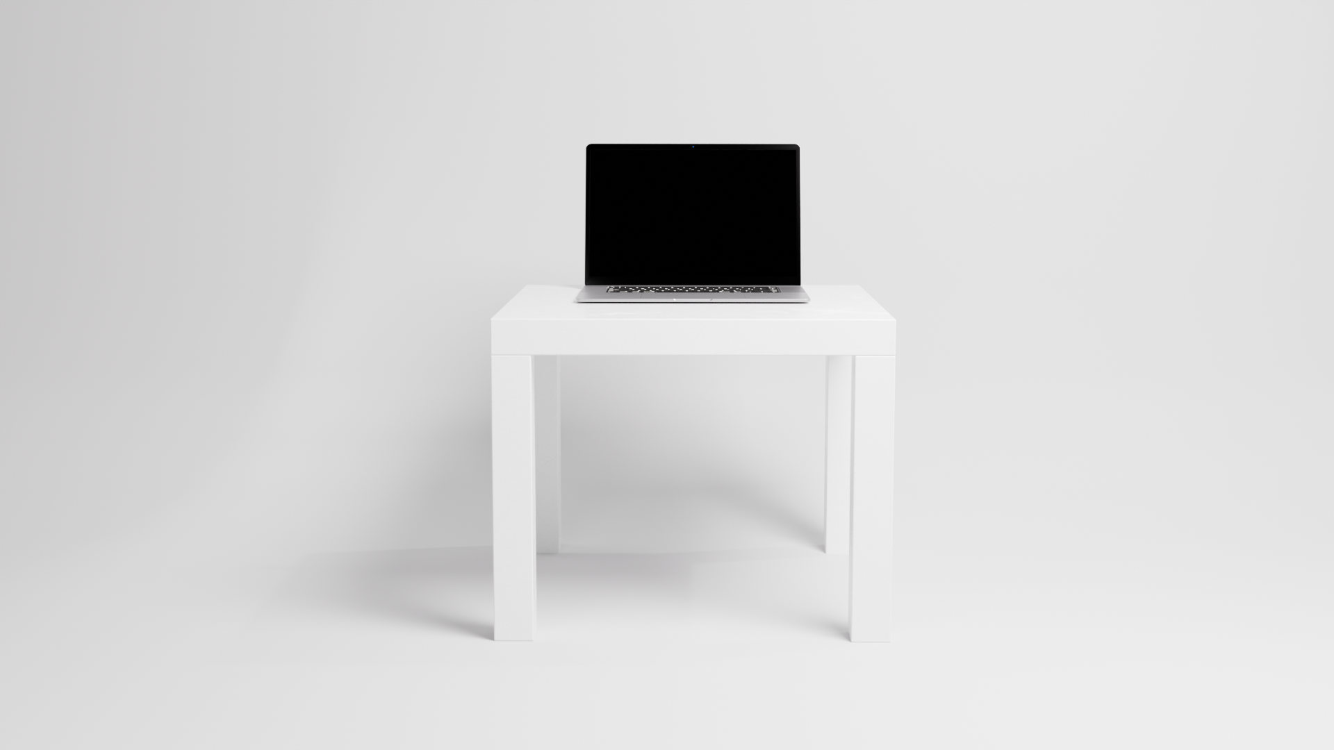 A laptop. An IKEA table. A white background. 