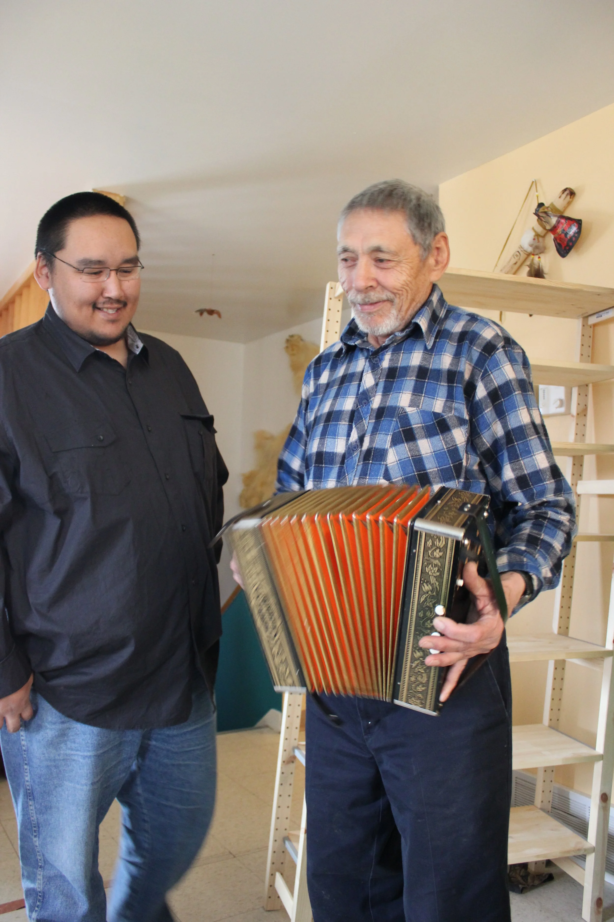George Kudlu, accordionist, with his son, Wemindji, Eeyou Istchee, Québec. November 2011. Photograph by Frances Wilkins.