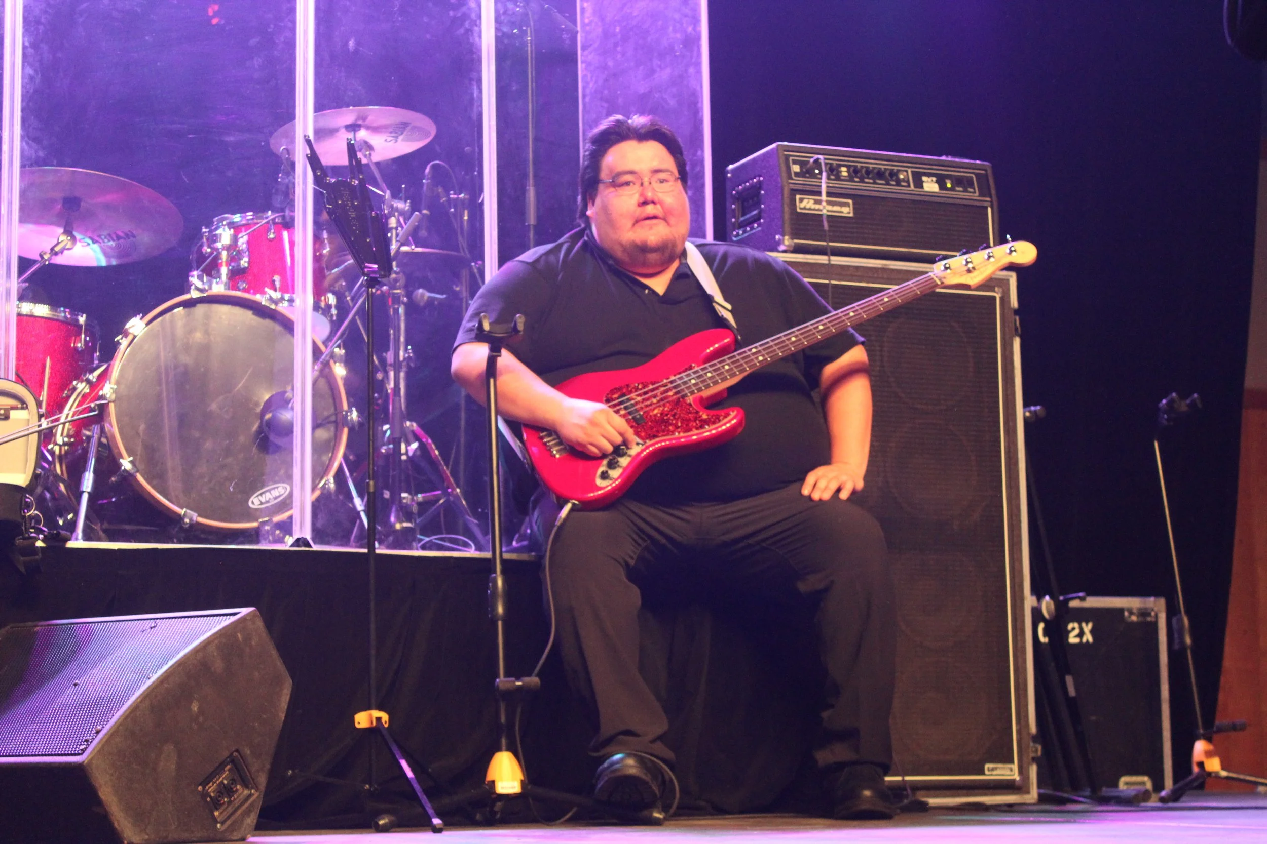 Electric guitarist onstage in Waskaganish, Eeyou Istchee, Québec. March 2018. Photograph by Frances Wilkins.