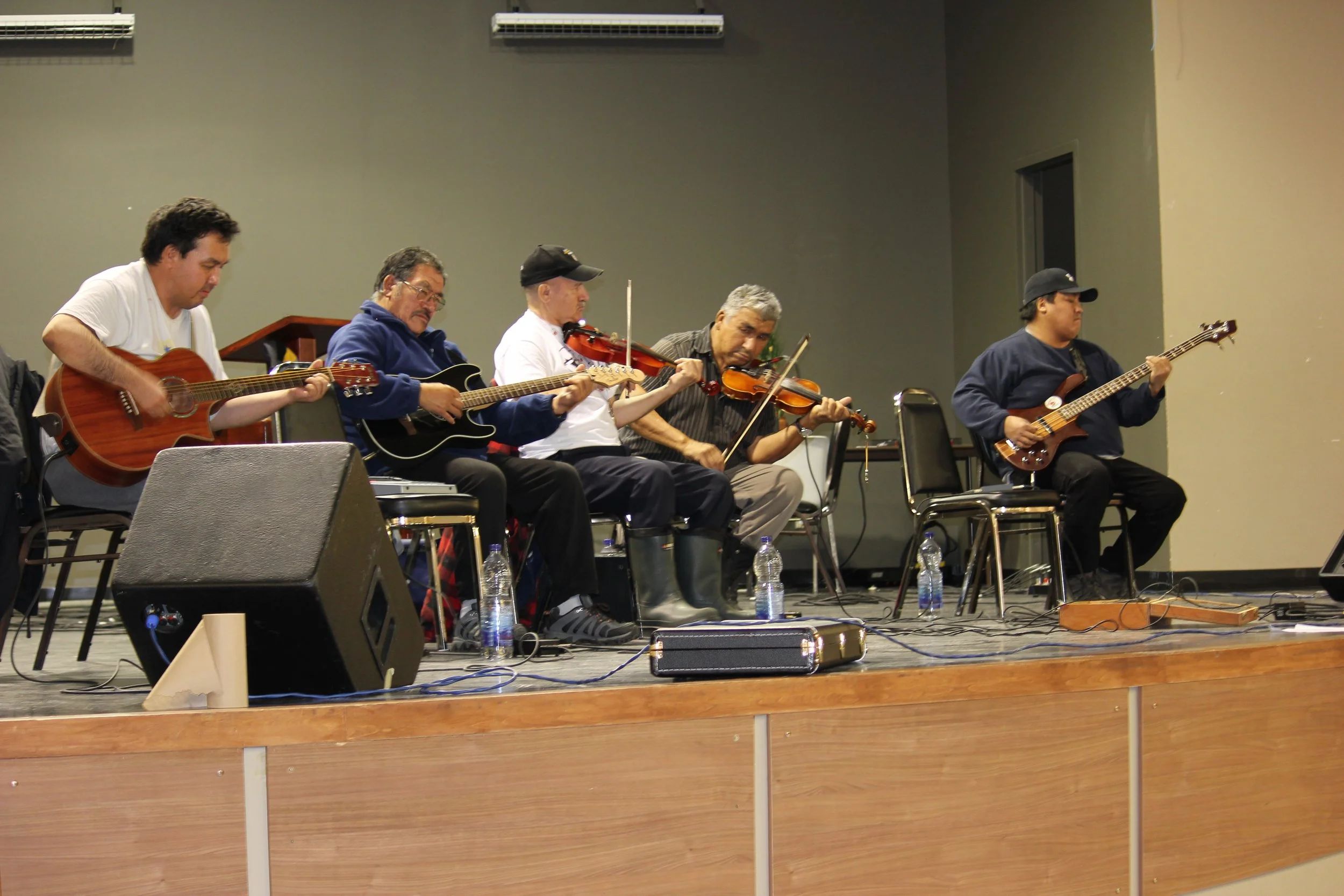 Bobby Georgekish, James Stewart and band performing in Wemindji, Eeyou Istchee, Québec. November 2011. Photograph by Frances Wilkins.