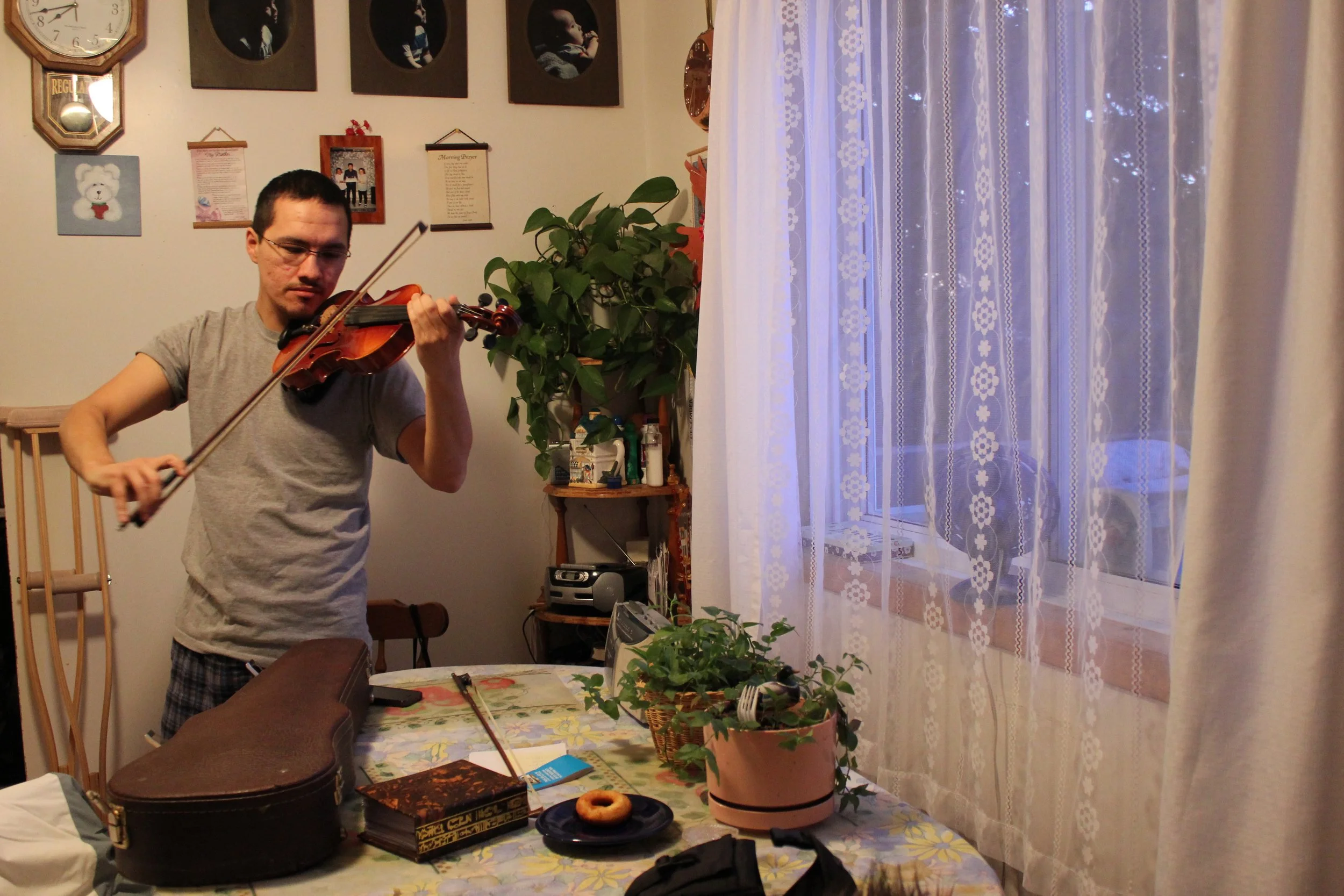 Clarence Louttit's grandson playing fiddle, Moose Factory, Northern Ontario, December 2011. Photograph by Frances Wilkins. 