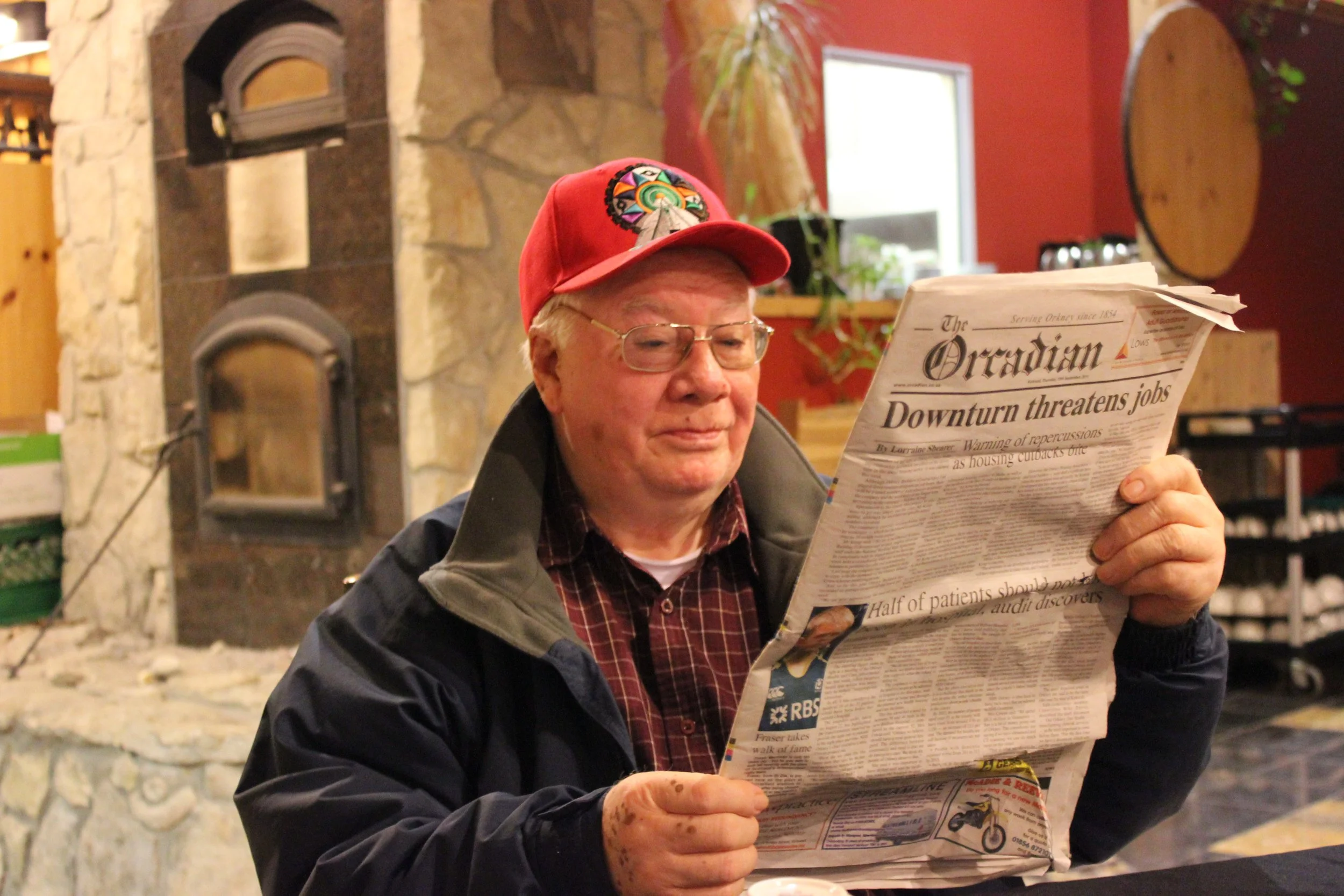 James Cheechoo, fiddler, reading The Orcadian newspaper, Cree Village Ecolodge, Moose Factory, Northern Ontario, December 2011. Photograph by Frances Wilkins. 
