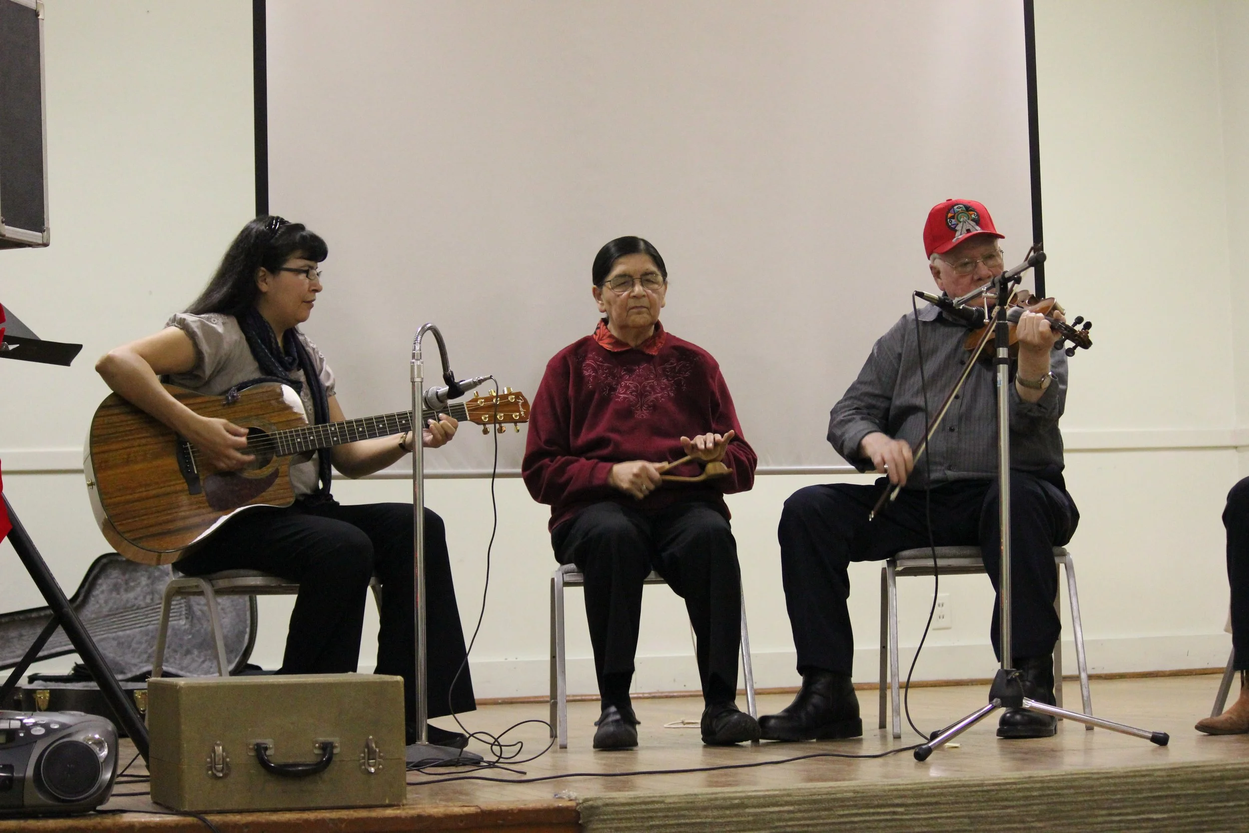 Treena, Daisy and James Cheechoo performing at pot-luck event, Oshawa, Ontario, December 2011. Photograph by Frances Wilkins. 
