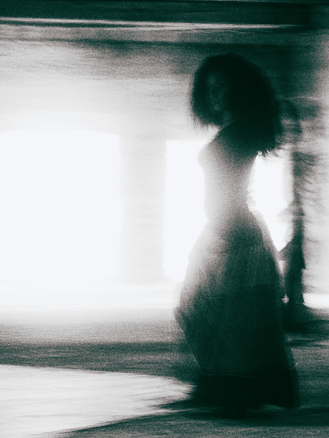 Silhouette of a woman kneeling in a light filled room — representing the emotional experience buyers have inside online business environments analyzed by Smith + Soma.