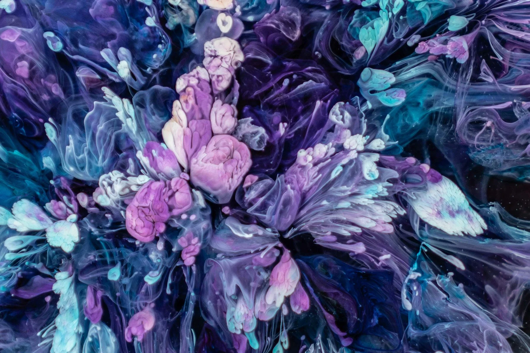 A vibrant, abstract mix of swirling purple, pink, blue, and white colors resembling ink in water.