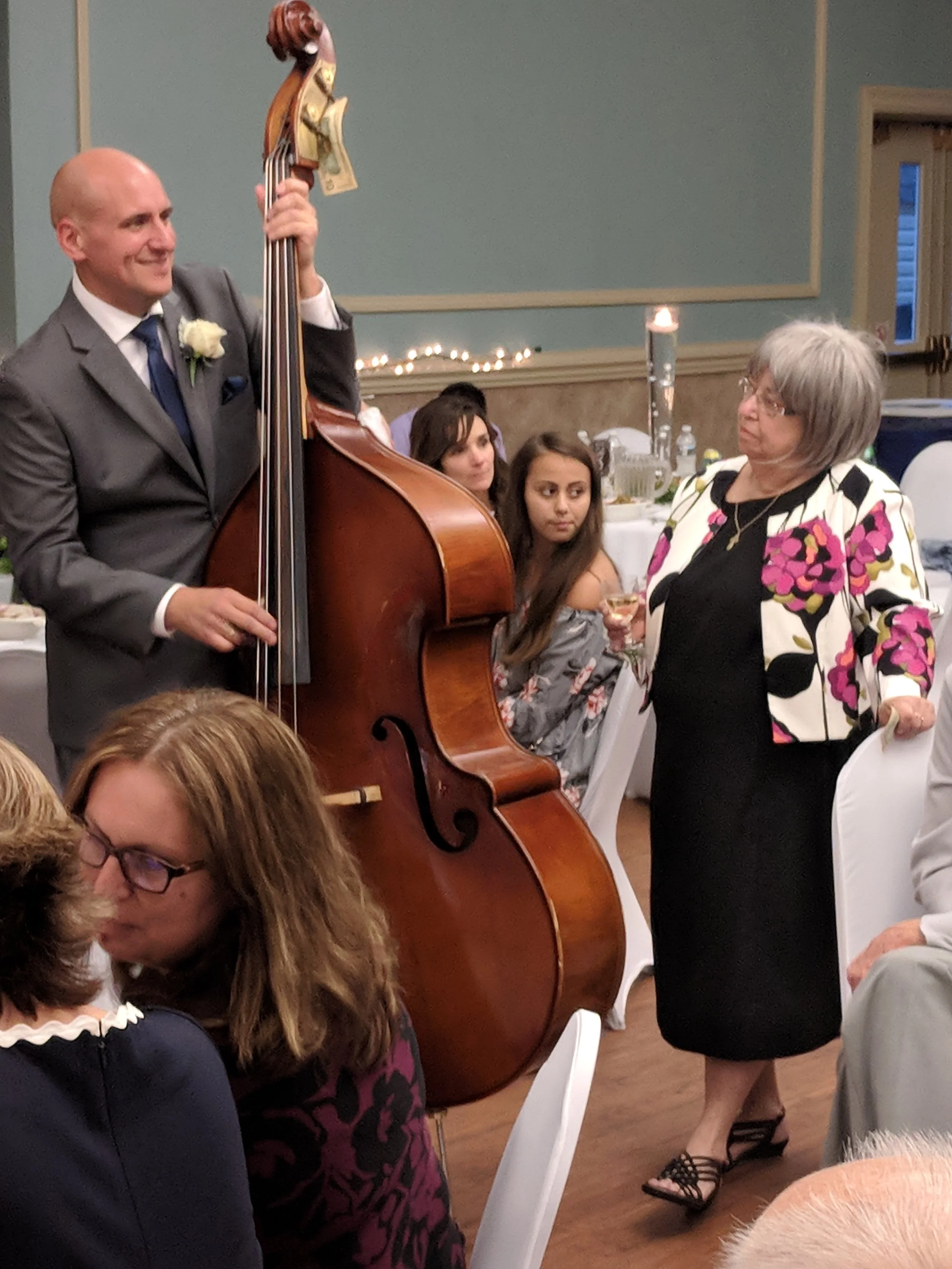 Christopher Radanovic playing the upright bass, symbolizing the balance and harmony he brings to small business financials.