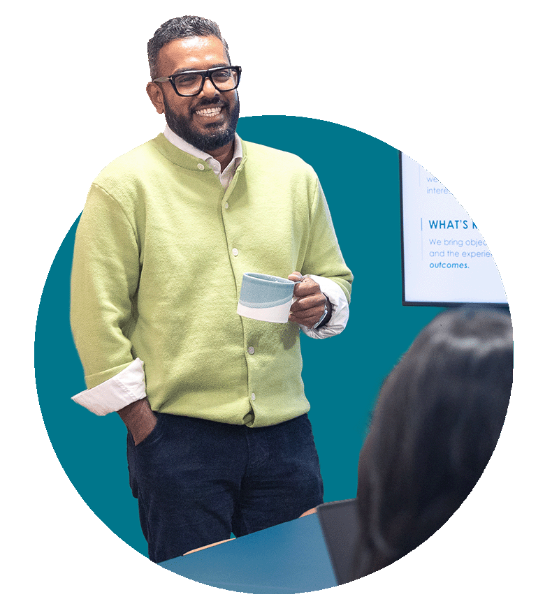 Smiling man chatting to colleagues