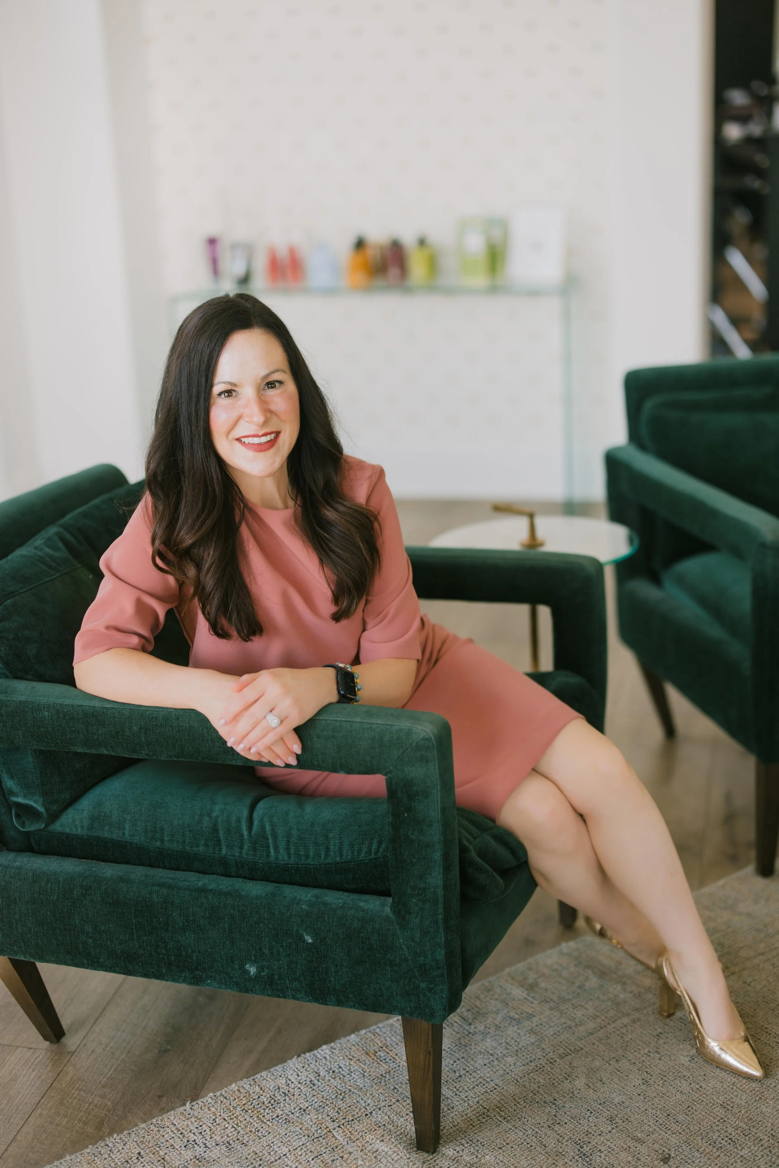 Dr. Ammons seated in a green chair, smiling warmly