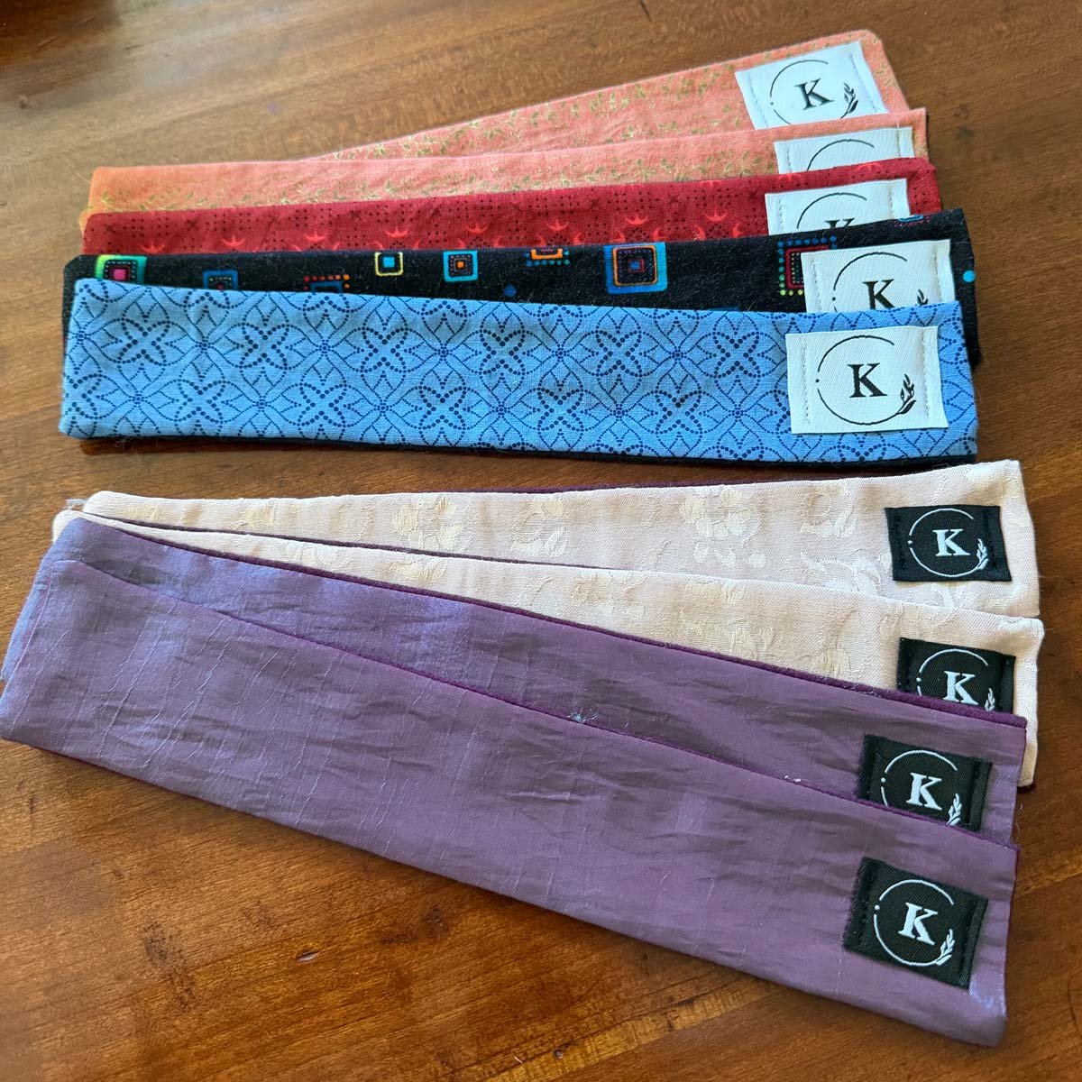 An array of handmade anti-tarnish cloths in different colors and patterns.