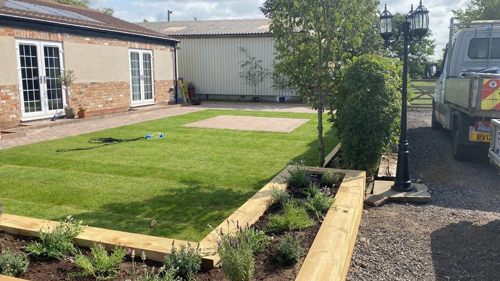 Landscaping with new lawn and raised sleeper beds in West Yorkshire
