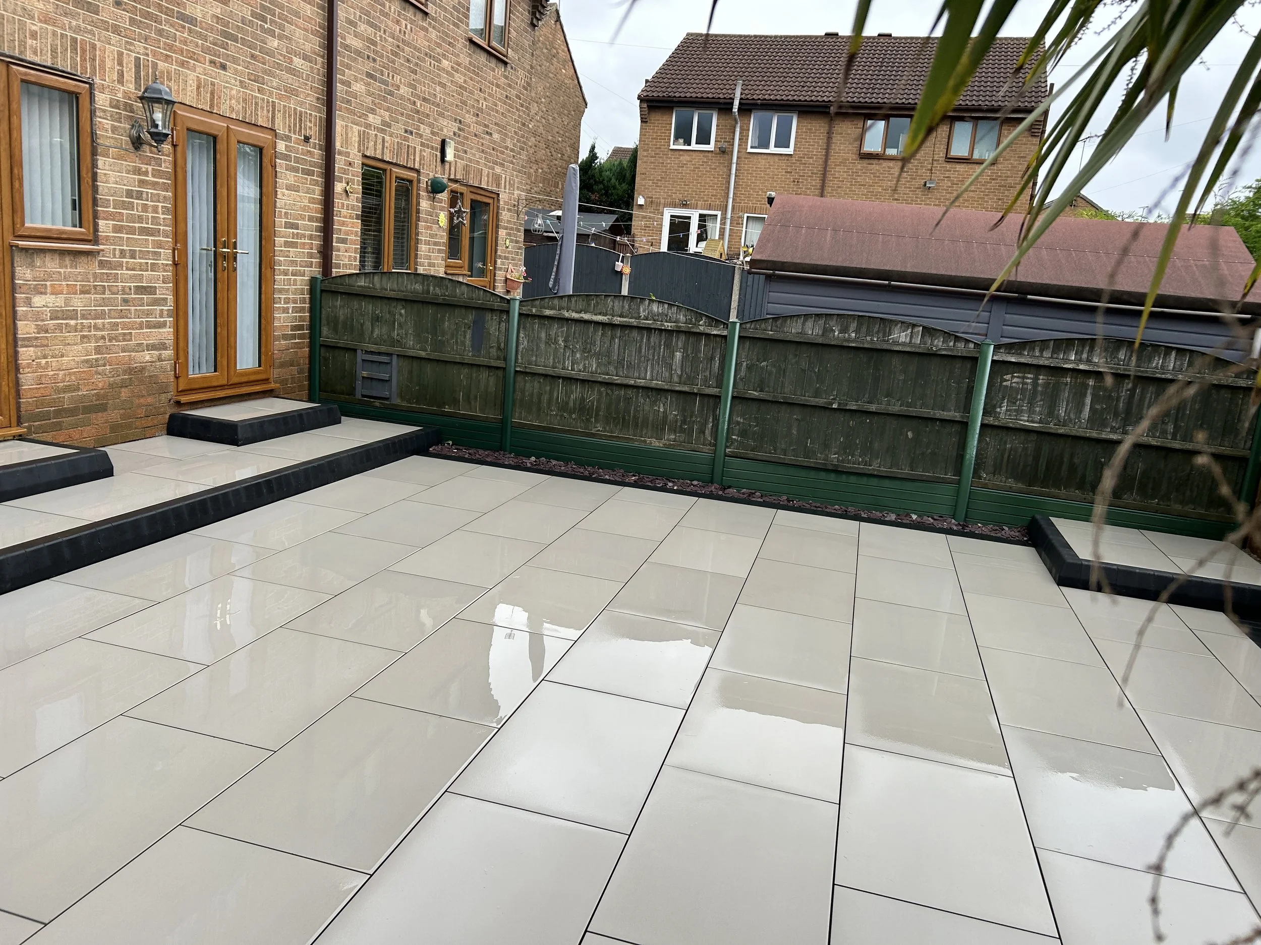 Large scale patio completion by Elite Construction at a residential property with multiple steps and block edging.