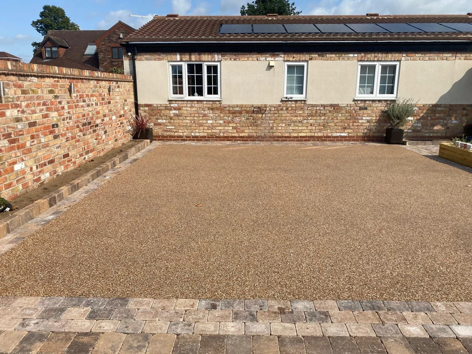 Resin driveway installation with block surround and landscaping in West Yorkshire