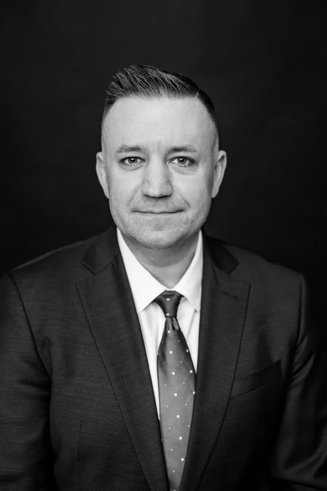 Michael Thiessmeier, AI and cybersecurity executive, in a black-and-white formal portrait.