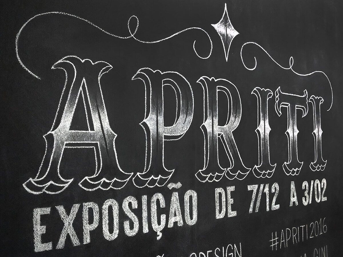 Chalkboard showing the word 'APRIL' in large decorative letters, with additional text mentioning an exhibition from July 12 to August 3, 2016, and hashtags like #APRIL2016.